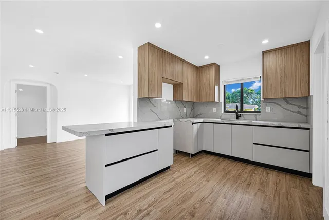 a view of hallway with wooden floor and staircase