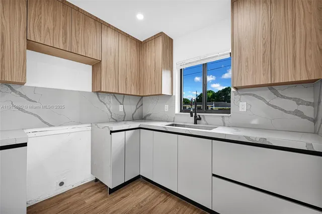 a view of living room with furniture and wooden floor