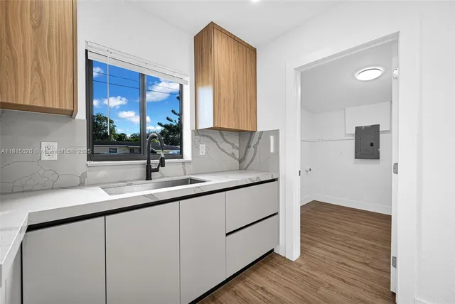 wooden floor in an empty room with a window