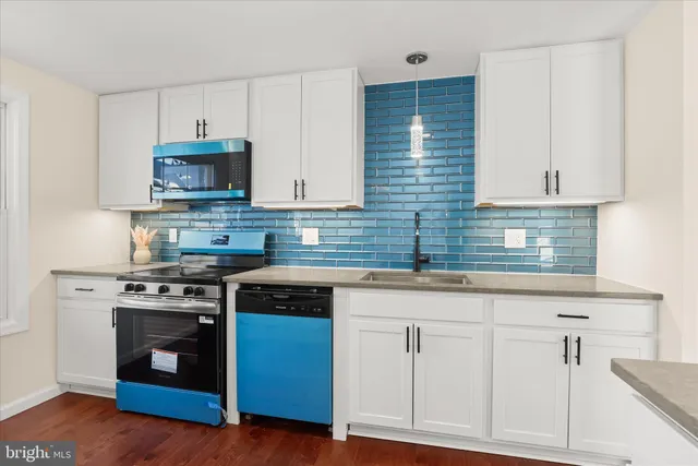 a kitchen with stainless steel appliances a refrigerator and cabinets