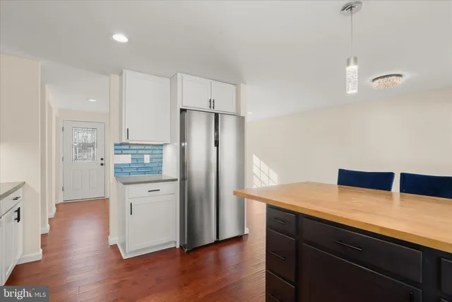 a view of a room with wooden floor and a window
