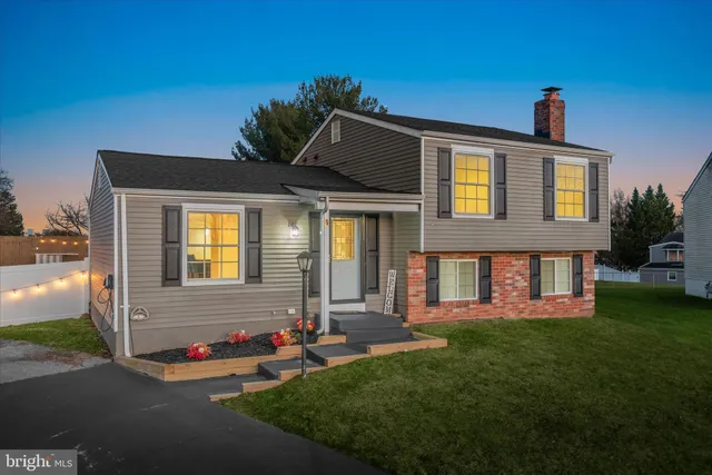 a view of a house with a porch and furniture