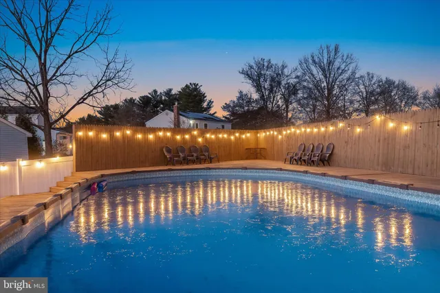 a view of swimming pool with outdoor seating and yard