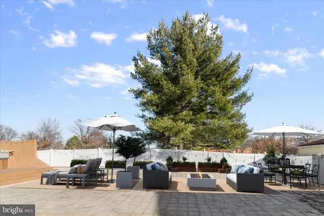 a view of an empty room with wooden floor and a fireplace