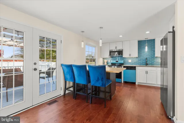 a kitchen with stainless steel appliances a stove a microwave and cabinets