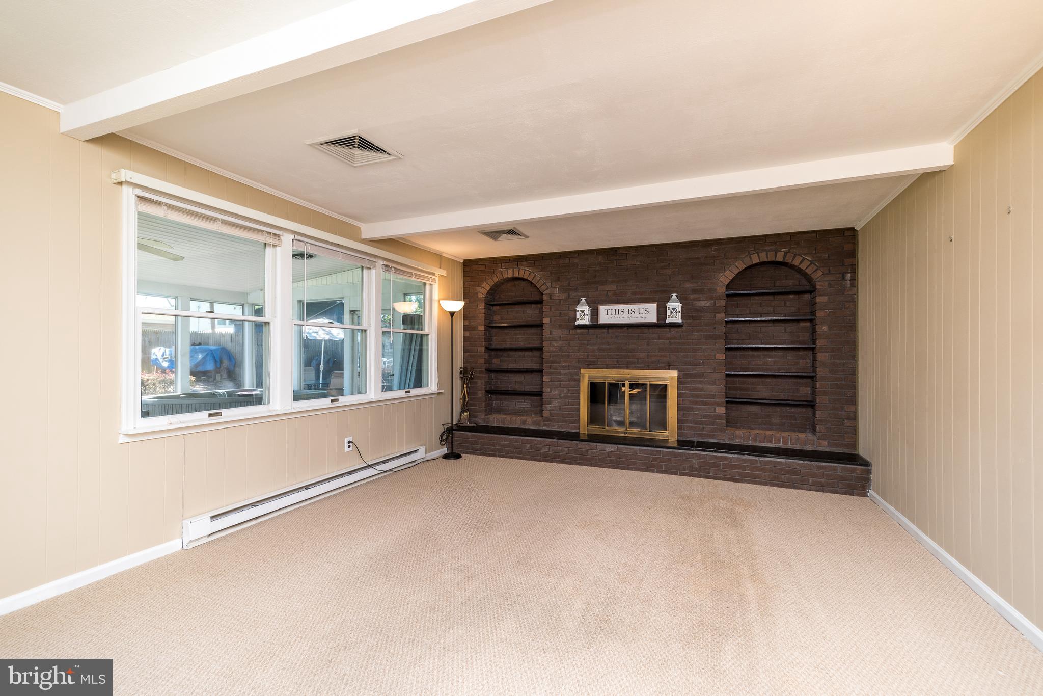 231 Parry Road Warminster, PA 18974 - Photo 24 of 71 a view of an empty room with a fireplace and a window