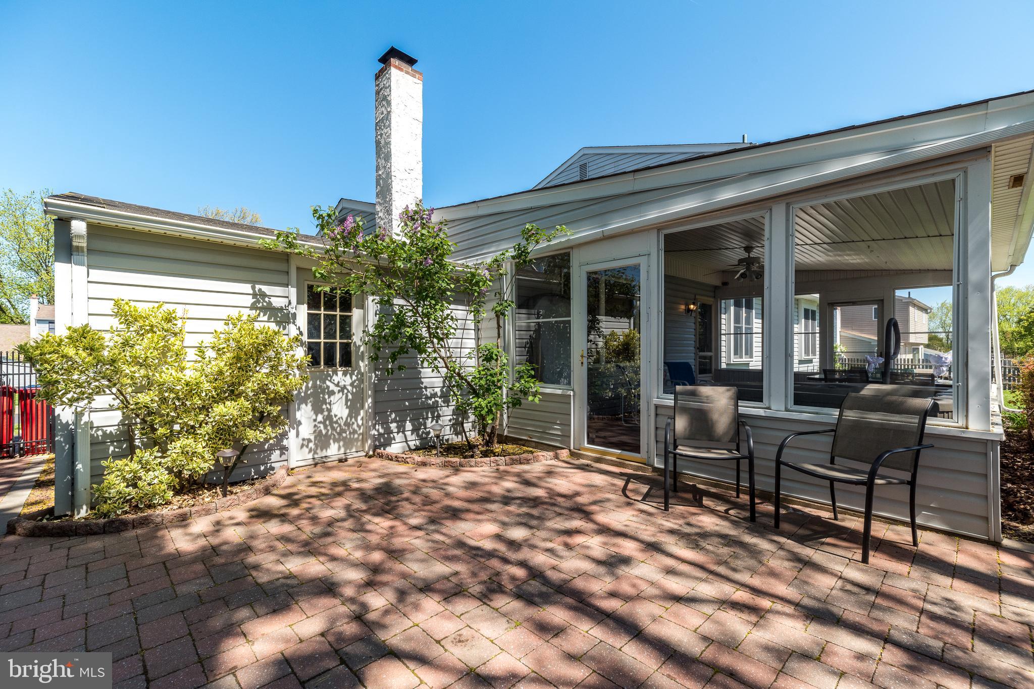 231 Parry Road Warminster, PA 18974 - Photo 56 of 71 a porch with a table and chairs and potted plants
