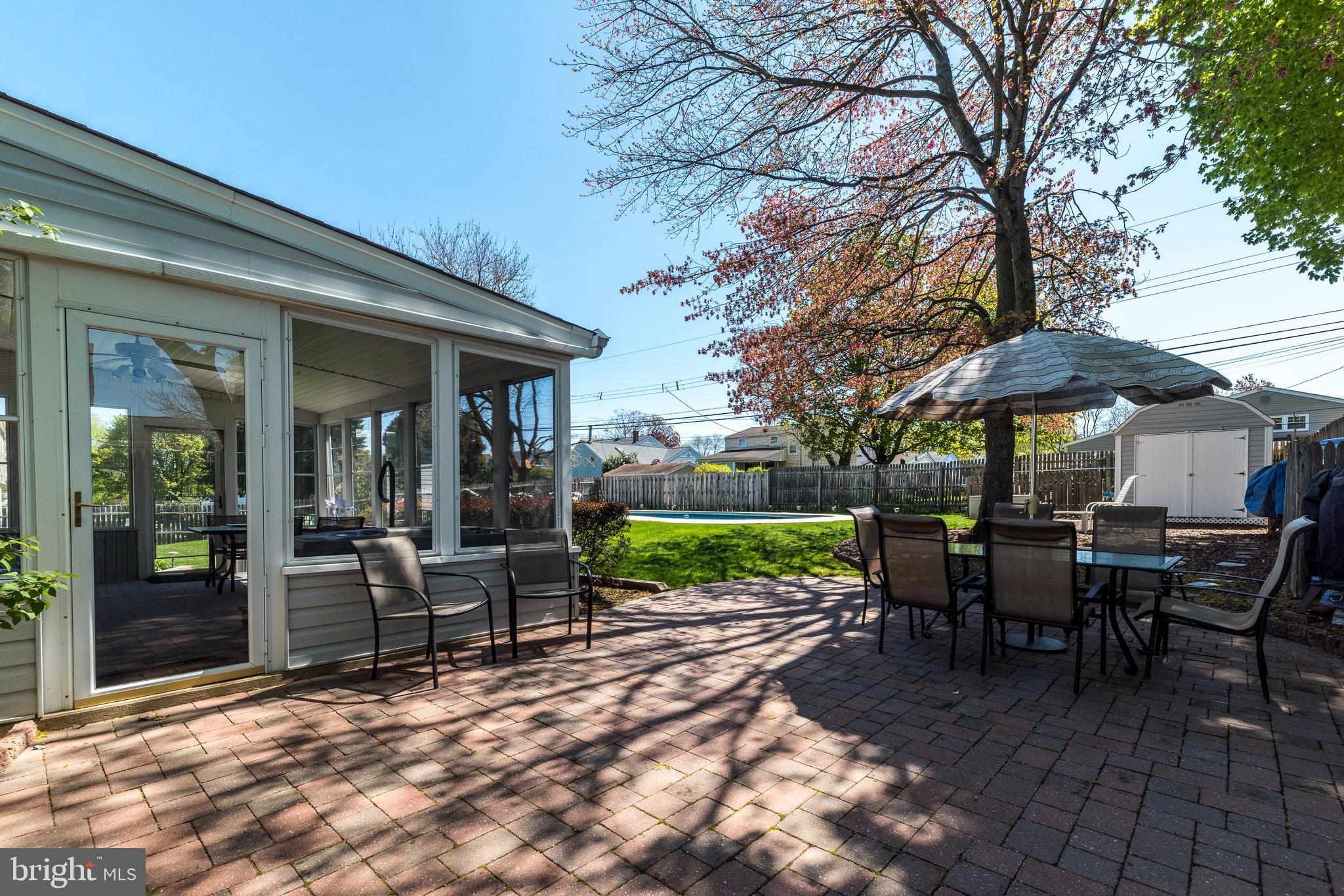 231 Parry Road Warminster, PA 18974 - Photo 57 of 71 a view of a tables and chairs under an umbrella in backyard