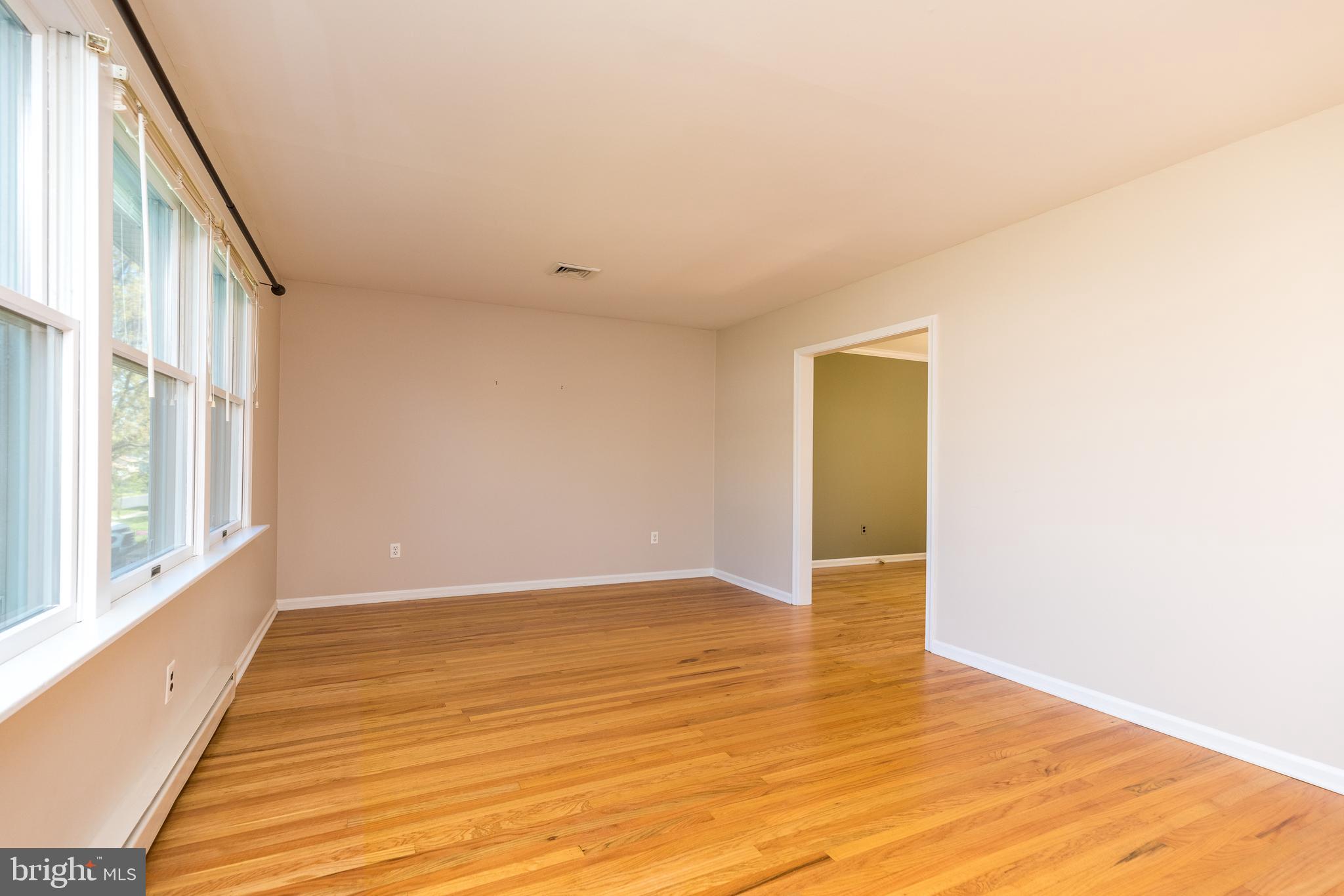 231 Parry Road Warminster, PA 18974 - Photo 9 of 71 a view of an empty room with wooden floor and a window