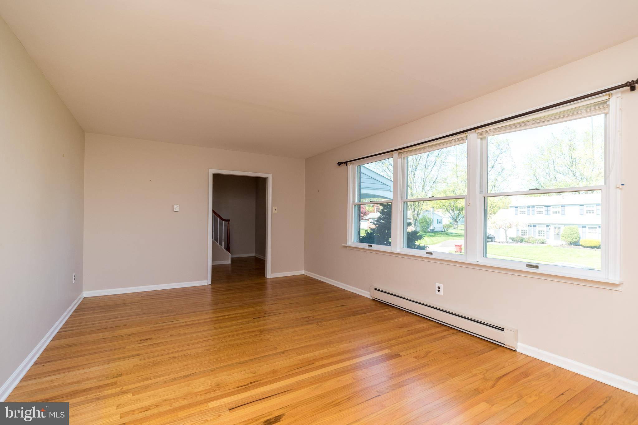 231 Parry Road Warminster, PA 18974 - Photo 10 of 71 a view of an empty room with wooden floor and a window
