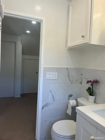 a white toilet sitting next to a bathroom sink