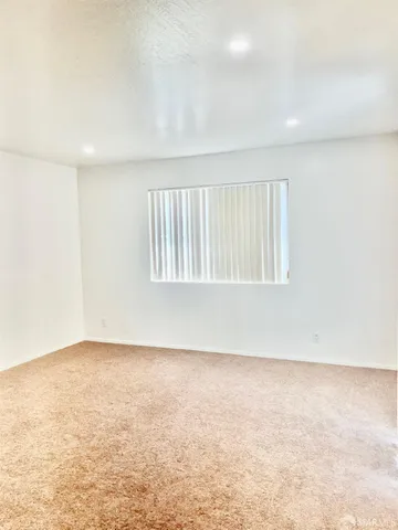 an empty room with a empty space and a window