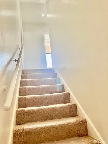 a view of staircase with white walls