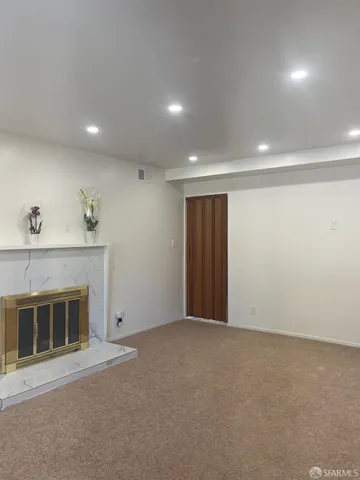 a view of an empty room with a fireplace