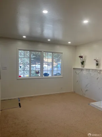 an empty room with a empty space and windows