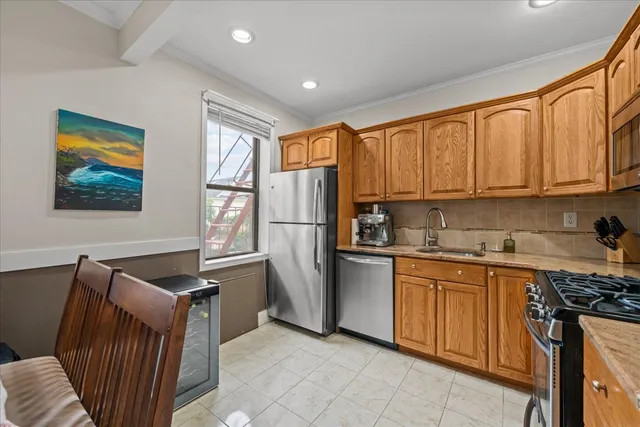 a kitchen with stainless steel appliances granite countertop a refrigerator stove top oven and sink