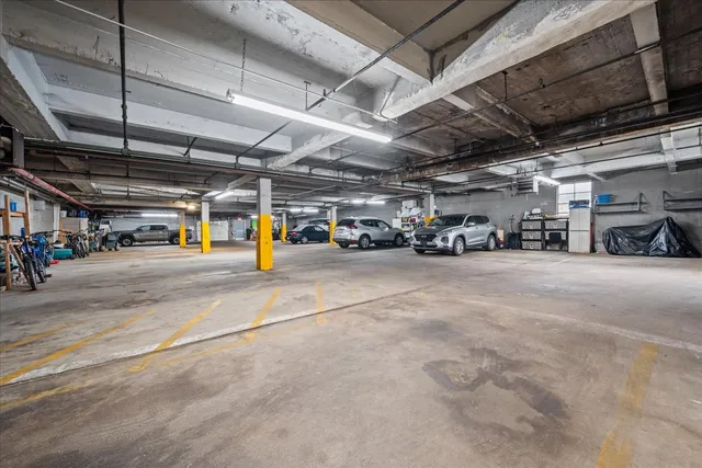 a view of parking garage with cars