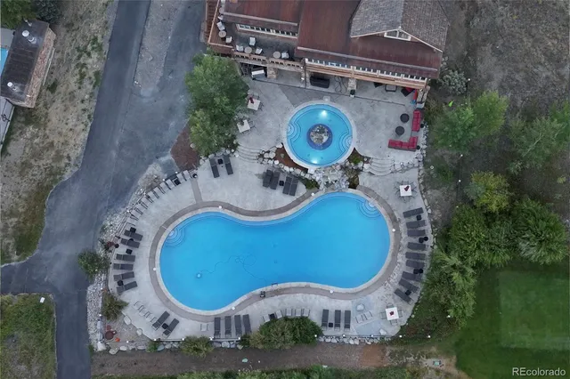 an aerial view of a house with garden space and outdoor seating