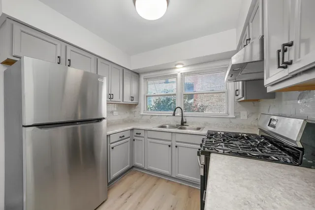 a white refrigerator freezer sitting inside of a kitchen