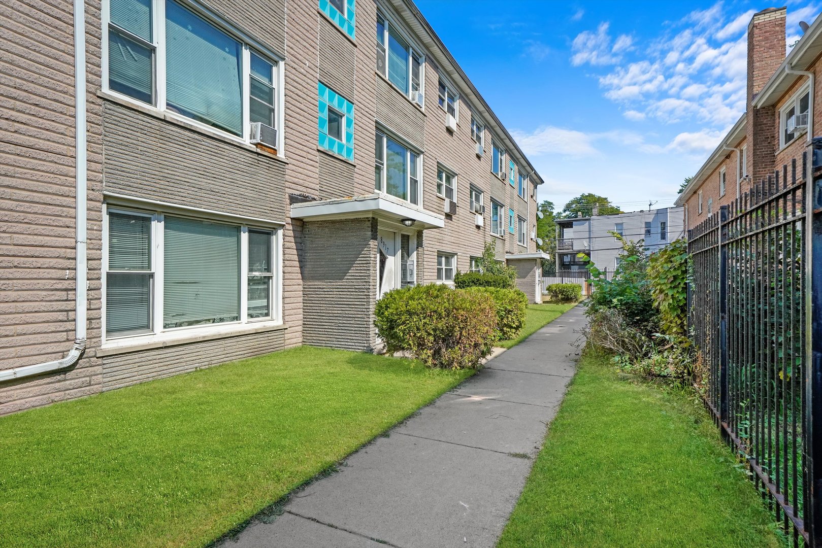 8917 South Cottage Grove Avenue Chicago, IL 60619 - Photo 3 of 17 a view of a brick house with a yard and plants
