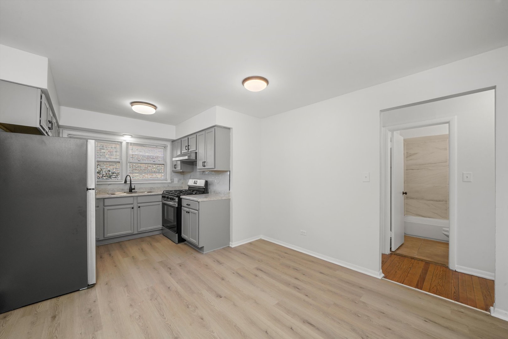 8917 South Cottage Grove Avenue Chicago, IL 60619 - Photo 9 of 17 a kitchen with a refrigerator sink and stove top oven