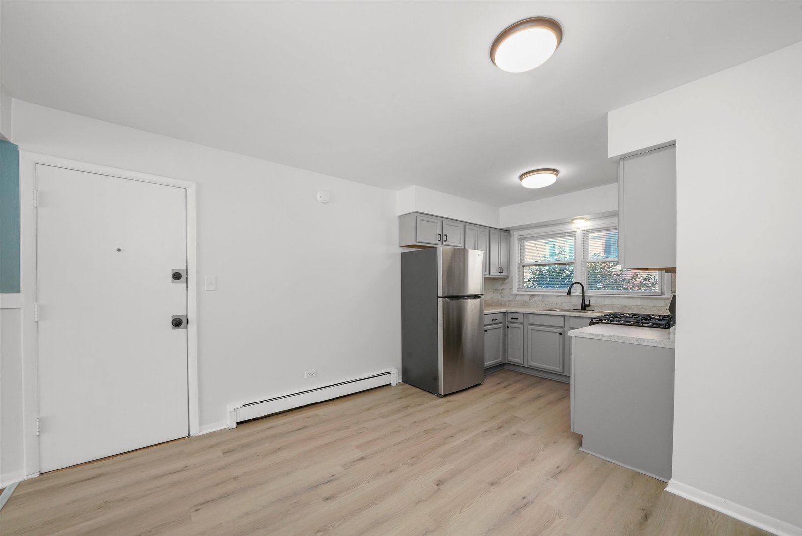 8917 South Cottage Grove Avenue Chicago, IL 60619 - Photo 10 of 17 a kitchen with stainless steel appliances granite countertop a refrigerator a sink dishwasher a stove top oven a washer and dryer