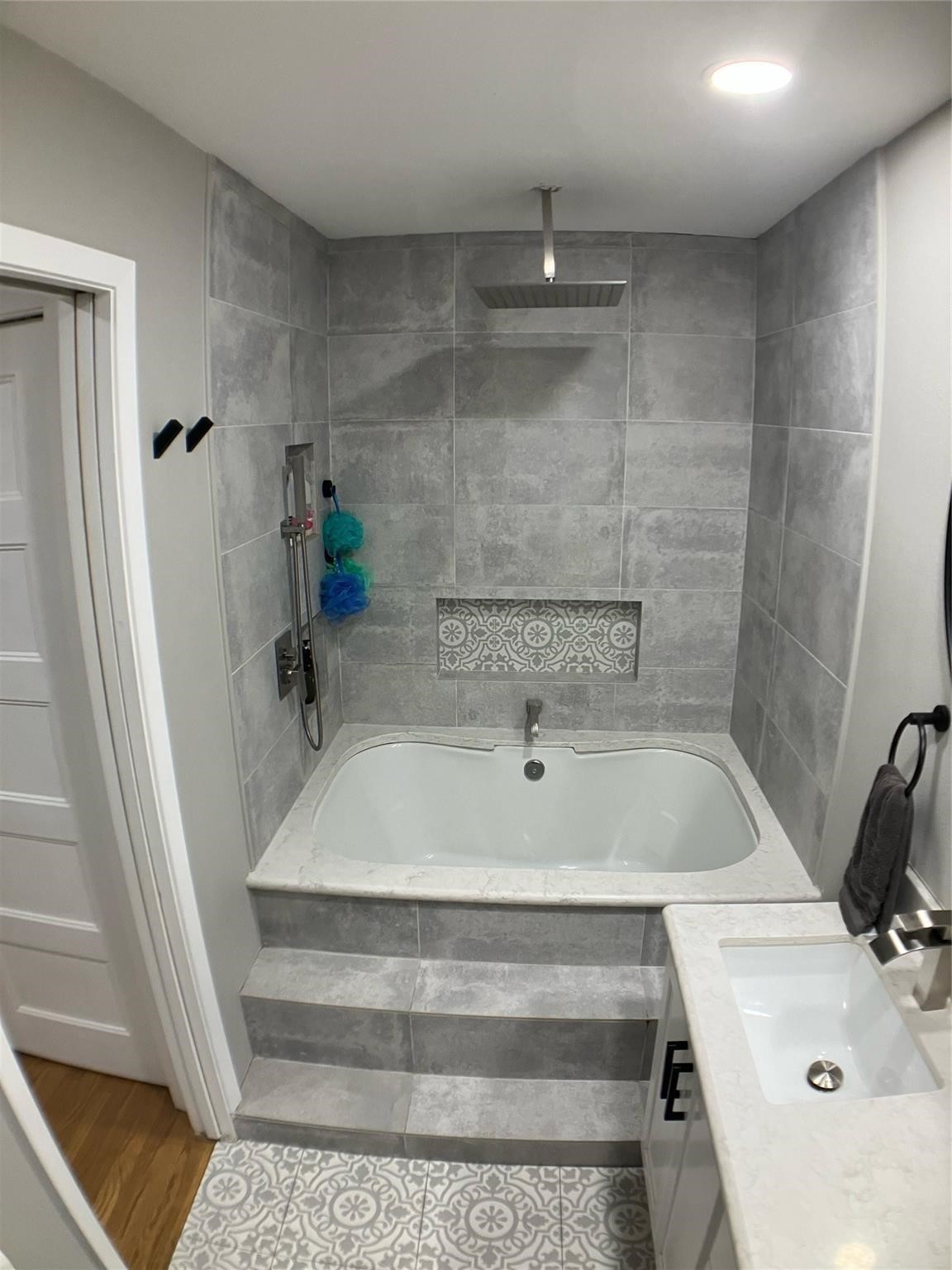 3027 Guese Road Houston, TX 77018 - Photo 11 of 22 Beautifully remodeled bathroom includes custom tile details and a clean, modern aesthetic.