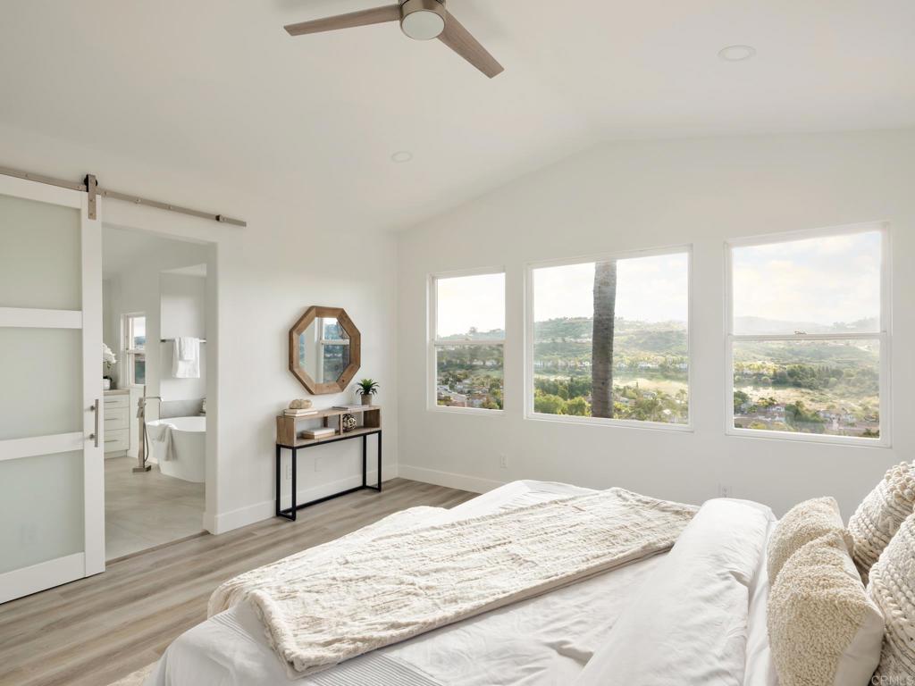 6160 Paseo Tapajos Carlsbad, CA 92009 - Photo 2 of 16 a living room with furniture a window and a chandelier