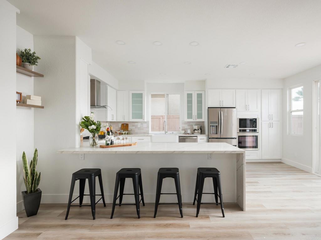 6160 Paseo Tapajos Carlsbad, CA 92009 - Photo 4 of 16 a kitchen with a table and chairs in it
