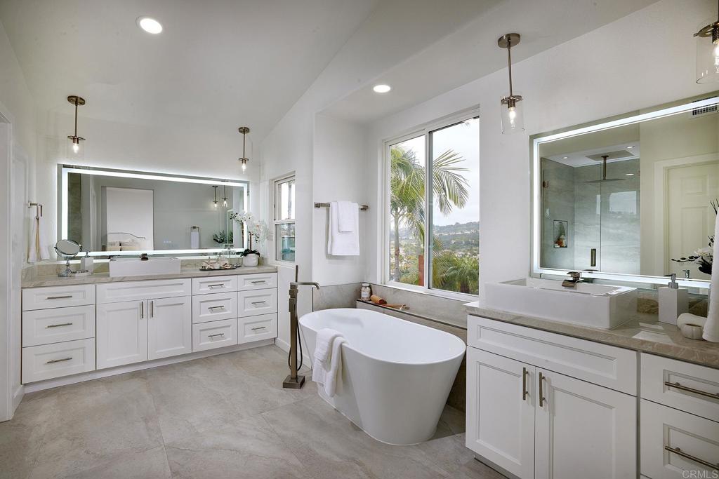 6160 Paseo Tapajos Carlsbad, CA 92009 - Photo 7 of 16 a spacious bathroom with a granite countertop sink mirror and a bathtub