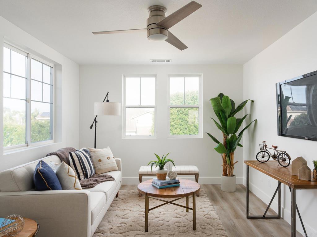 6160 Paseo Tapajos Carlsbad, CA 92009 - Photo 9 of 16 a living room with furniture potted plant and windows