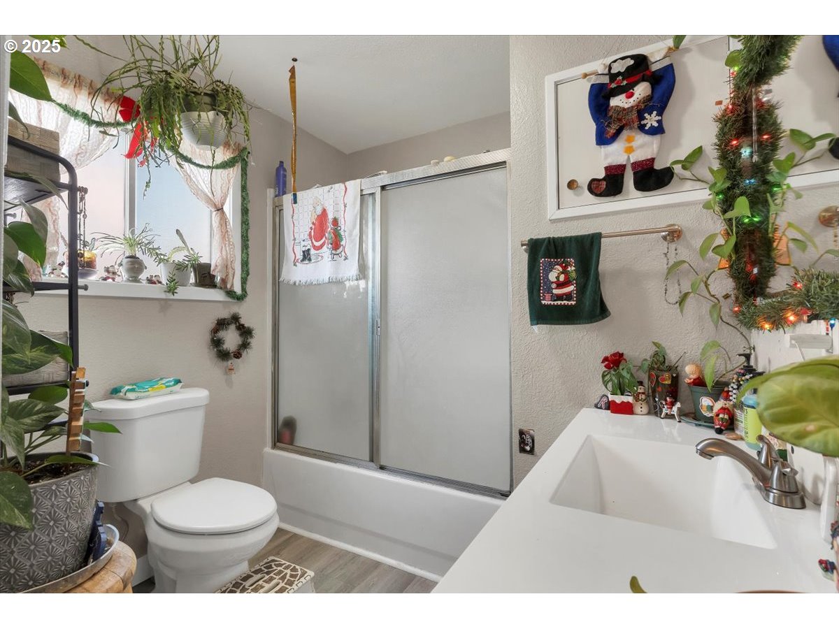 Undisclosed Address Lebanon, OR 97355 - Photo 13 of 34 a bathroom with a toilet a sink and a shower curtain