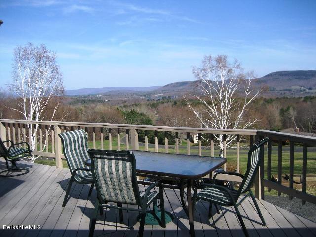 234 East Slope Road Richmond, MA 01201 - Photo 5 of 8 a view of a balcony with furniture and wooden floor