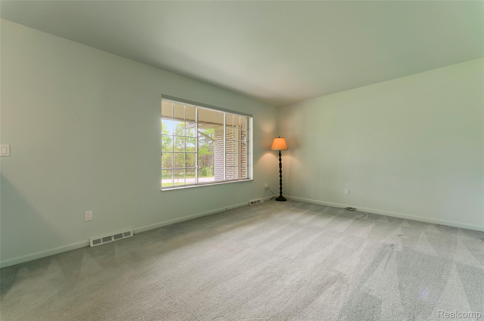8887 Clark Road Clarkston, MI 48346 - Photo 10 of 40 Empty room with baseboards and light carpet