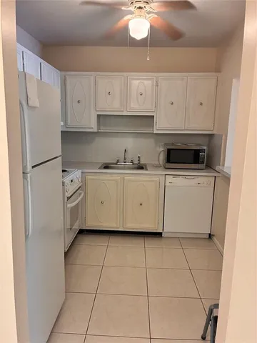 a kitchen with stainless steel appliances a stove a refrigerator and cabinets