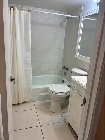 a bathroom with a toilet a sink and shower