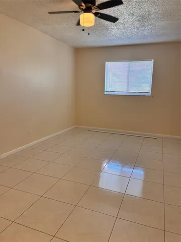 an empty room with a ceiling fan