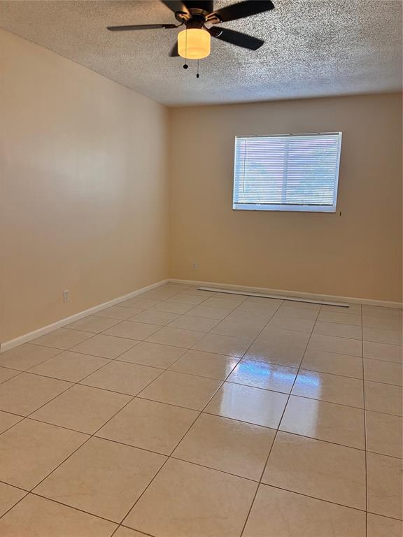 257 South Cypress Road, Unit 435 Pompano Beach, FL 33060 - Photo 7 of 18 an empty room with a ceiling fan