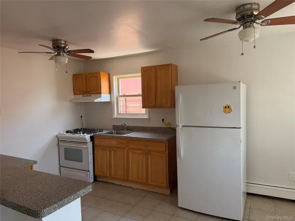 a view of a room with an empty space and a window