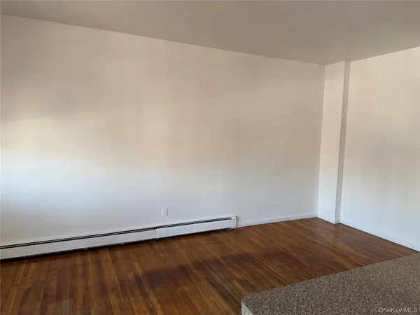 a view of wooden floor in an empty room