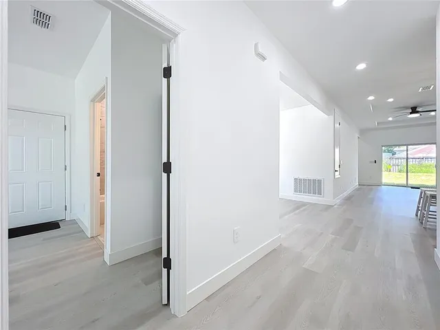 a kitchen with a sink a counter top space stainless steel appliances and cabinets