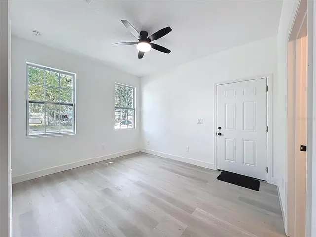 wooden floor in an empty room with a window