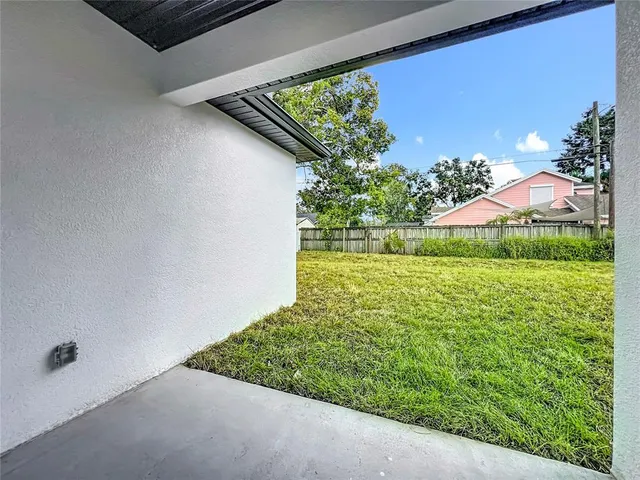 an aerial view of residential houses with outdoor space and street view