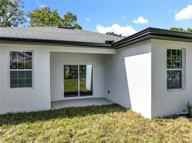 a spacious bedroom with a bed and a chandelier