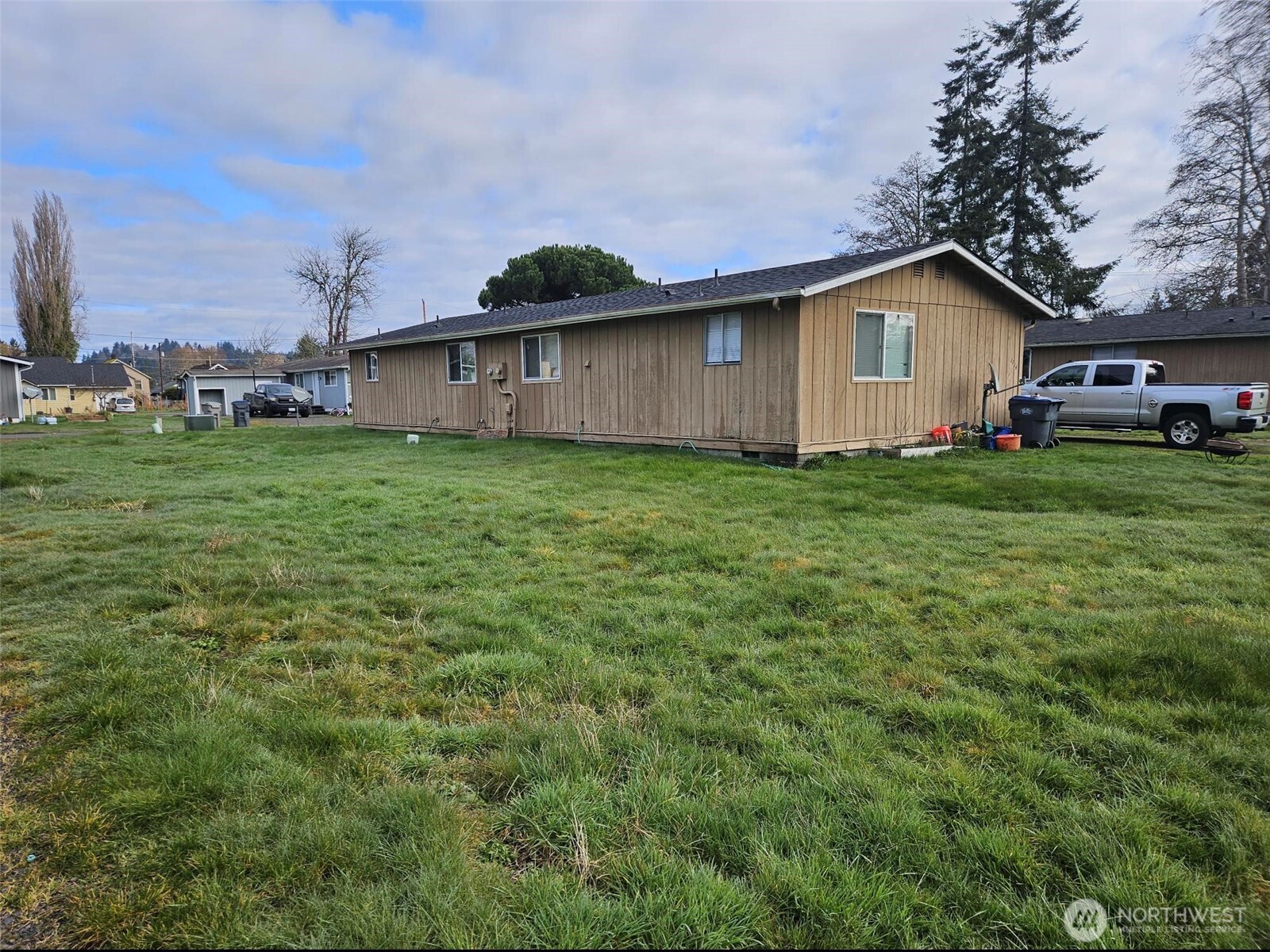1114 Fordney Street Aberdeen, WA 98520 - Photo 1 of 4 a view of a backyard with wooden fence