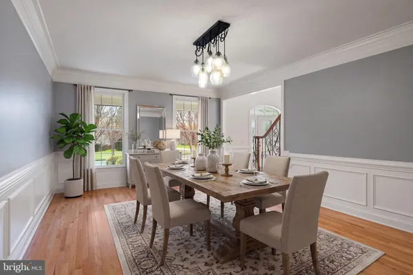 a view of a kitchen with kitchen island a sink stainless steel appliances and cabinets