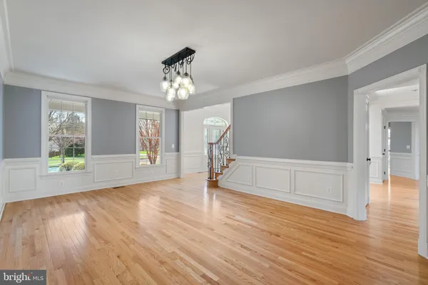 a view of empty room with wooden floor and cabinet