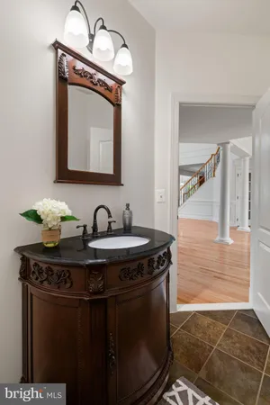 a bathroom with a toilet a sink and a mirror