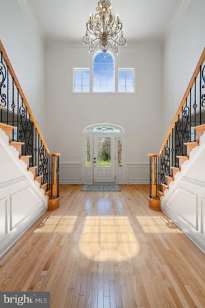 a kitchen with stainless steel appliances granite countertop wooden cabinets a sink dishwasher a stove and a refrigerator