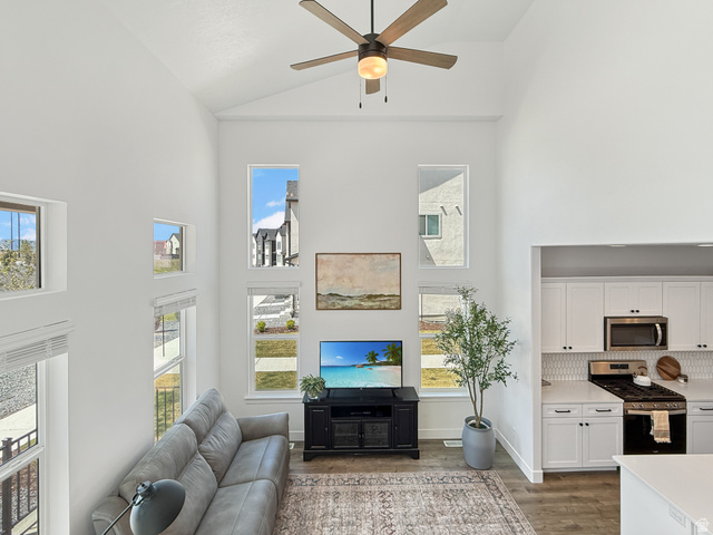 641 Desert Willow Drive Mapleton, UT 84664 - Photo 16 of 41 Living area with a ceiling fan, light wood finished floors, plenty of natural light, and vaulted ceiling